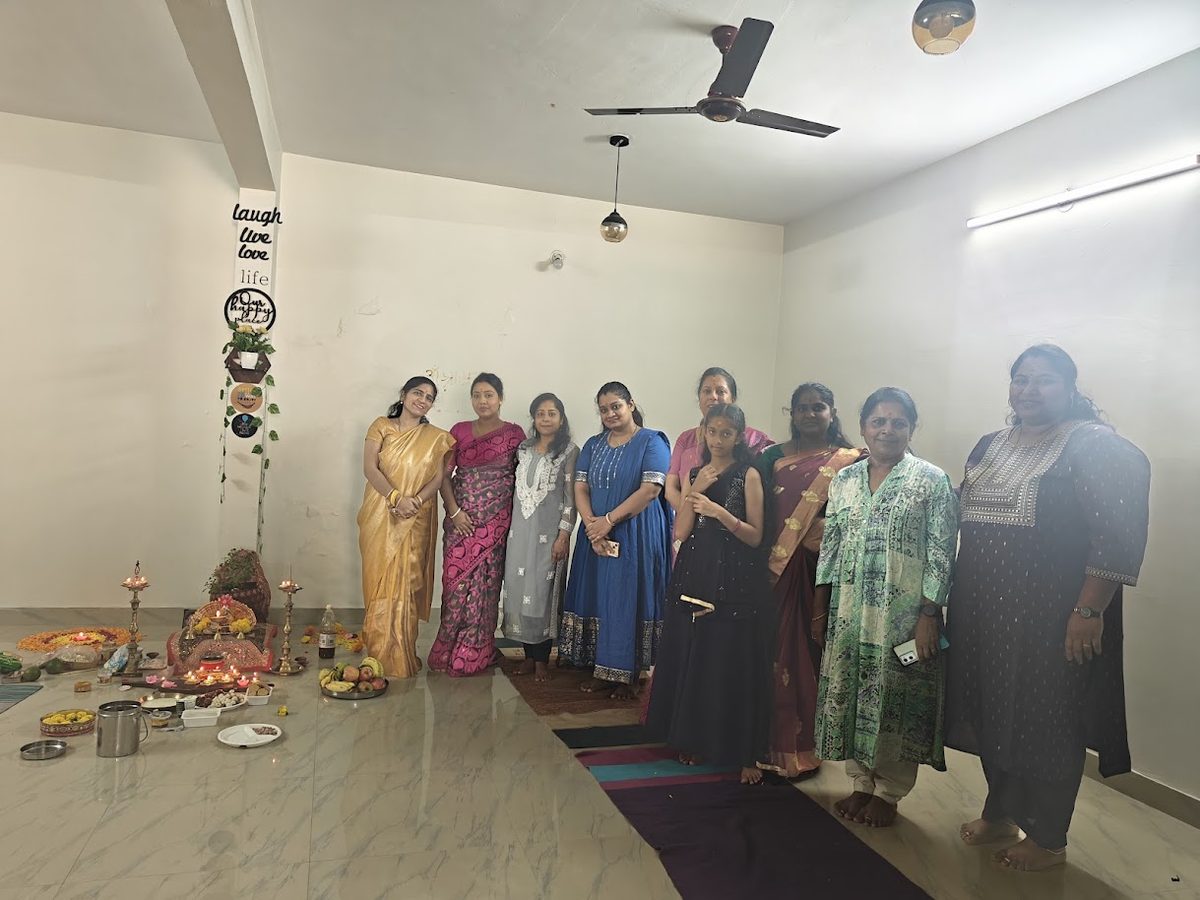 A group of women gathered in the studio around a festive lamp arrangement