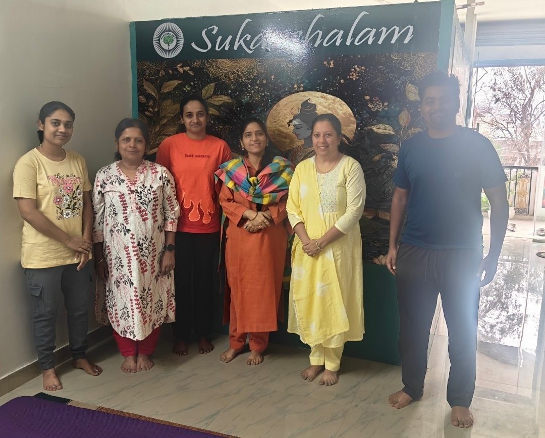 Dr. Kaushal with students in front of the Sukaushalam sign