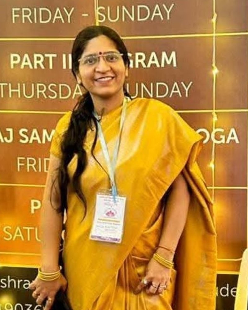 Dr. Deepika Kaushal smiling, in a yellow saree