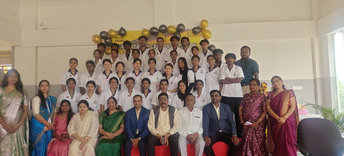 Dr. Kaushal with a large class of nursing students in white coats